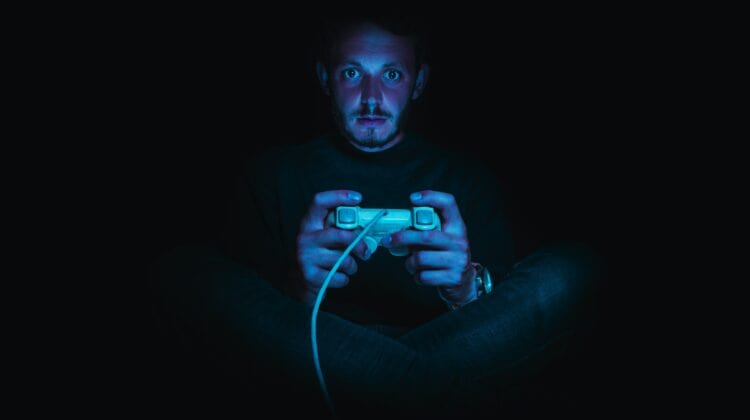 man holding corded gaming controller